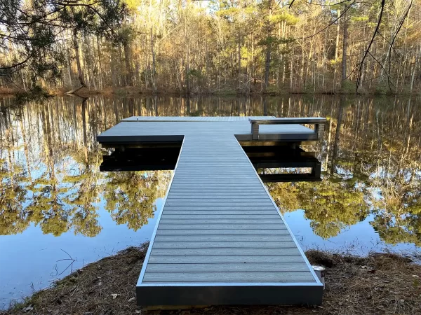 Dock on the lake with foliage reflecting in the water