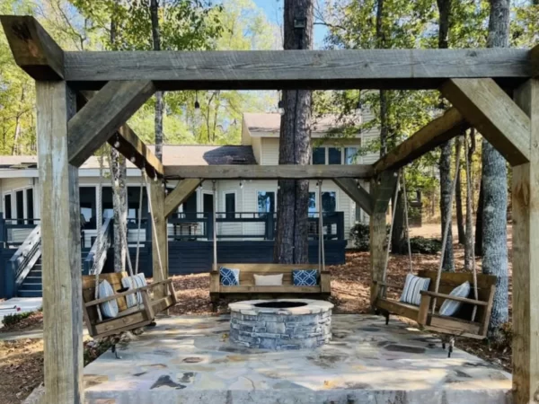 Fire pit surrounded by porch swings
