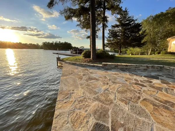 Decorative stonework patio by Lake Martin at sunset